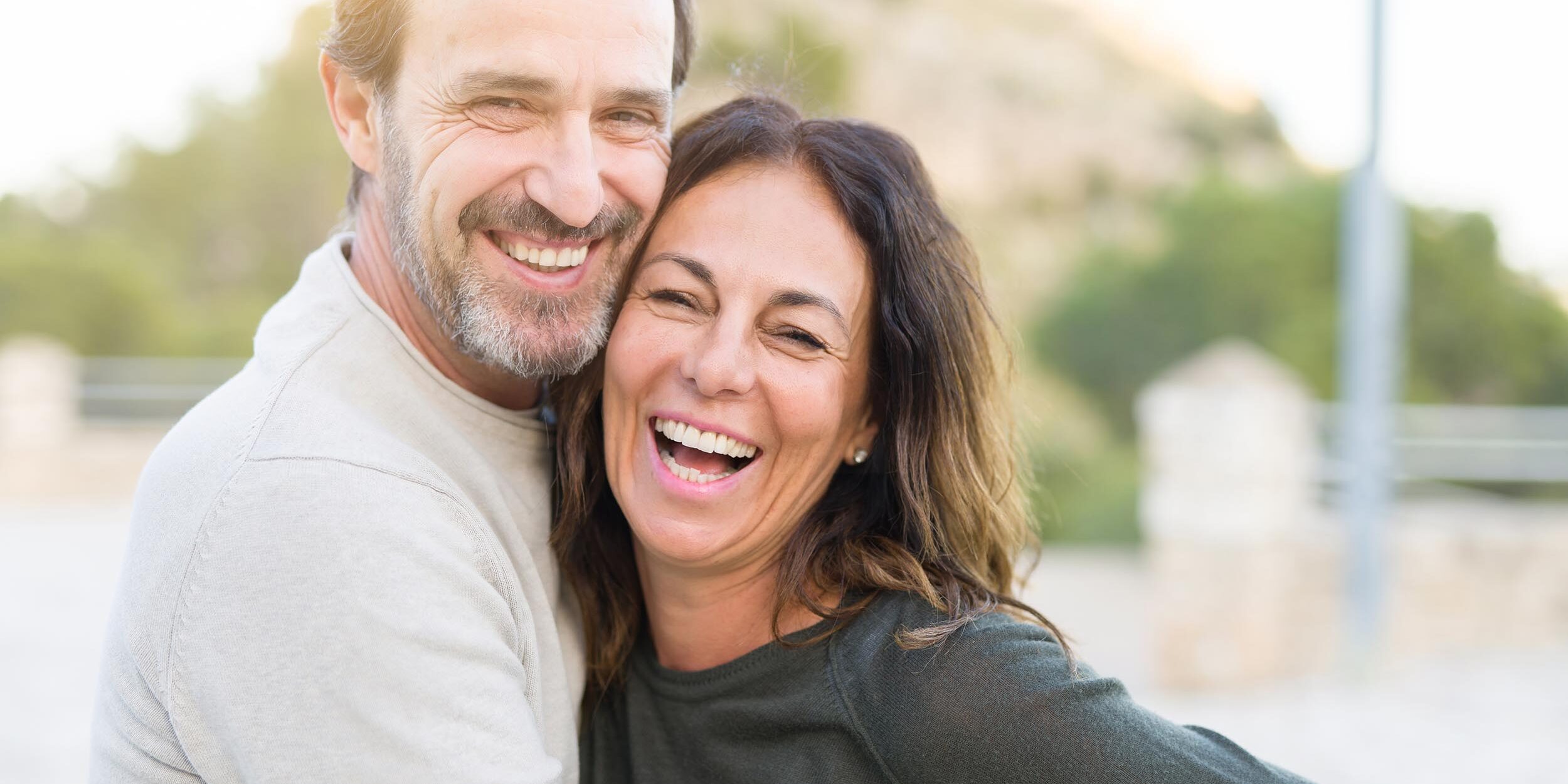 middle age couple smiling after their dental implant appointment