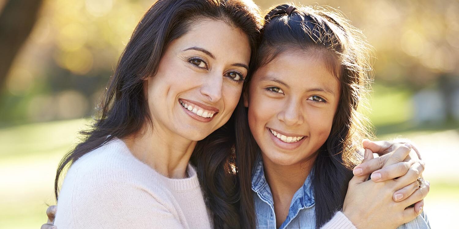 Mom and daughter smiling after clear braces appointment