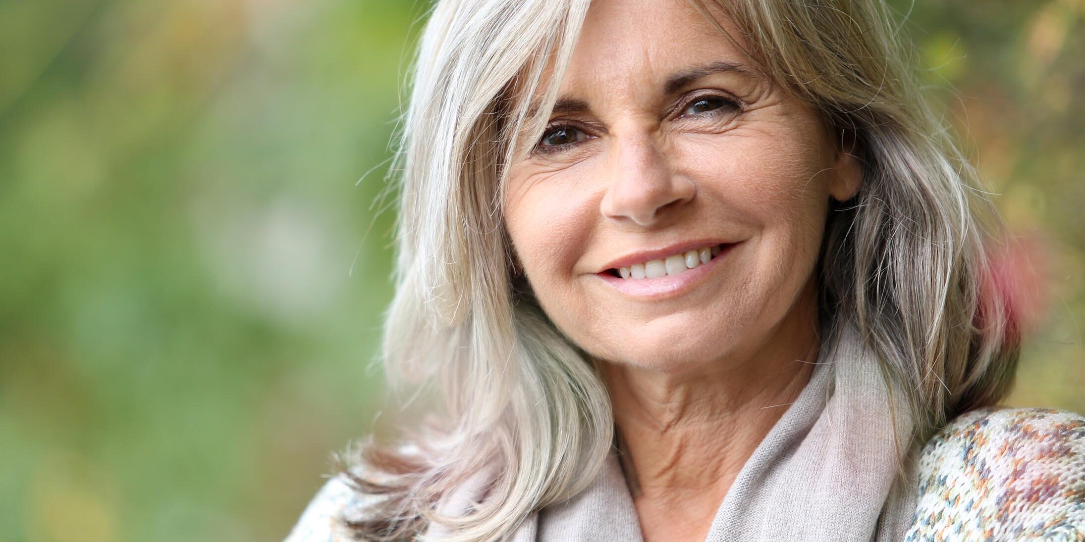 Beautiful elderly woman smiling after dental treatments